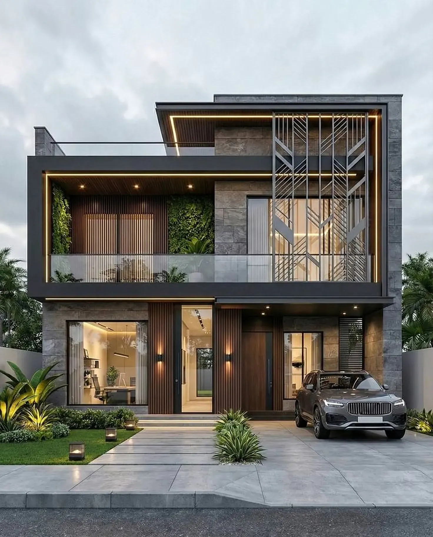 The finished home: a two-storey house with a charcoal fascia, stone-clad upper box with a metal screen, green wall, glass railings and a paved drive